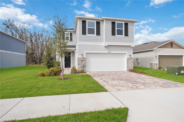 view of front of house with decorative driveway, a front lawn, stone siding, an attached garage, and stucco siding