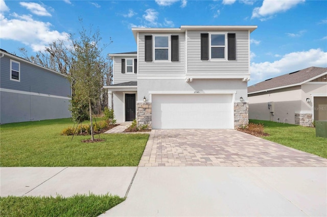 view of front facade featuring stone siding, a garage, a front yard, stucco siding, and decorative driveway