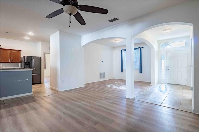 unfurnished living room featuring light hardwood / wood-style floors and ceiling fan