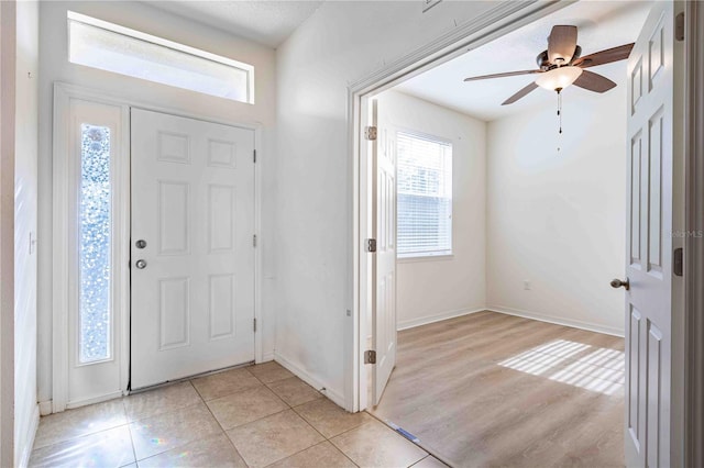 foyer with light hardwood / wood-style flooring and ceiling fan