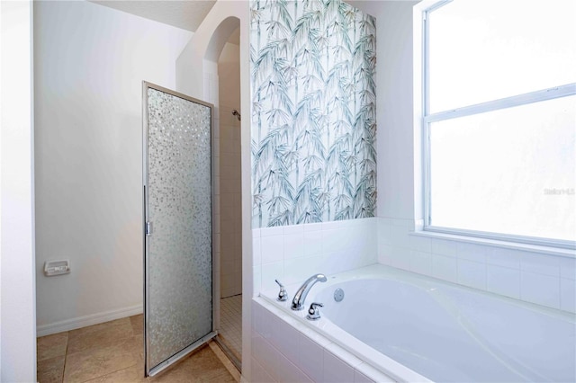 bathroom with tile patterned flooring and independent shower and bath