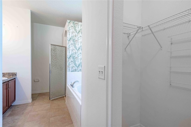 bathroom featuring tile patterned floors, vanity, and independent shower and bath