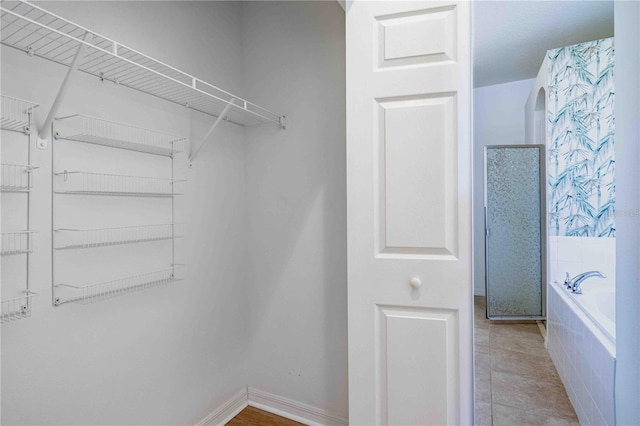 walk in closet with tile patterned floors