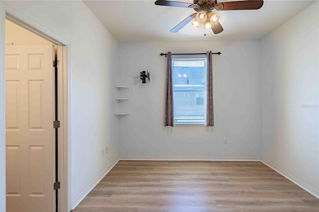 empty room featuring ceiling fan and light hardwood / wood-style floors