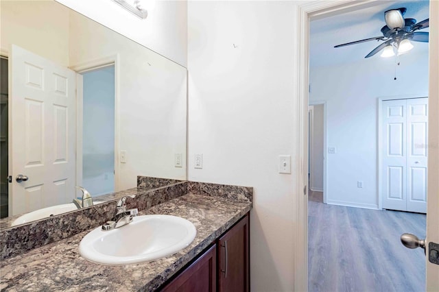 bathroom with hardwood / wood-style floors, vanity, and ceiling fan