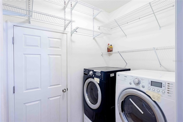 laundry area with separate washer and dryer