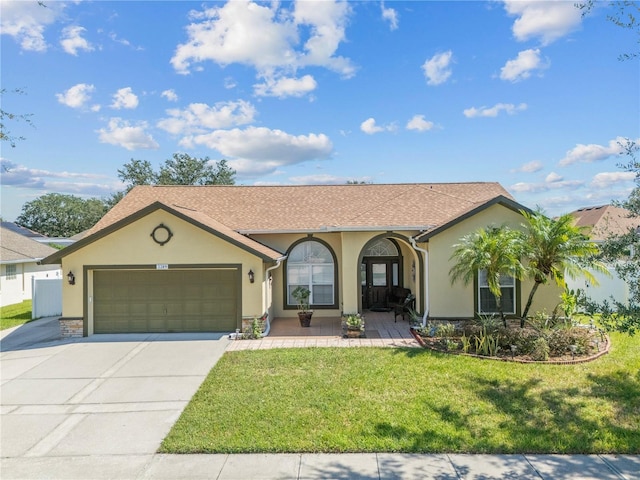 ranch-style home featuring a front lawn and a garage