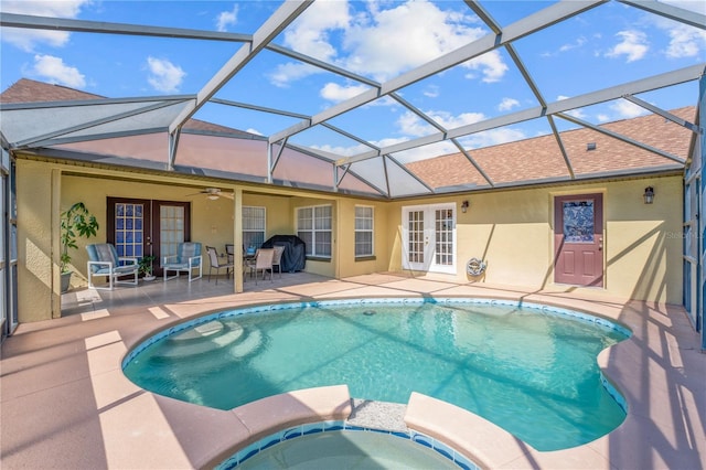 view of pool featuring an in ground hot tub, a patio area, french doors, a lanai, and ceiling fan