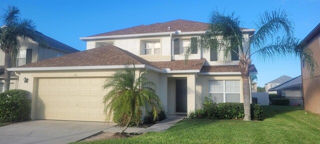 view of front of house featuring a front yard and a garage