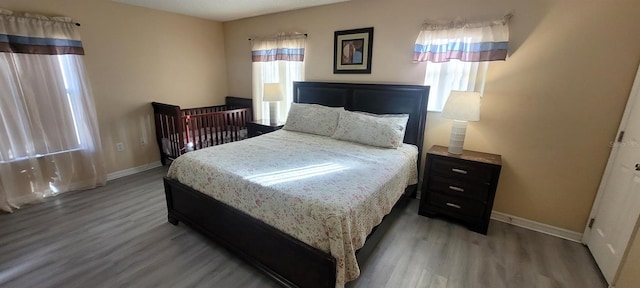 115 Canna Dr, Davenport, FL 33897 - bedroom featuring wood finished floors and baseboards