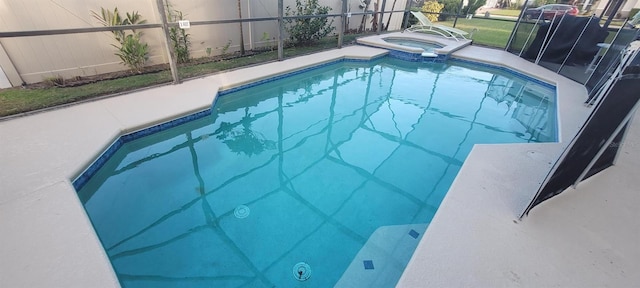 view of swimming pool featuring an in ground hot tub