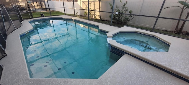 view of swimming pool featuring an in ground hot tub