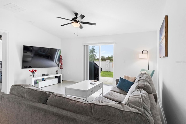 tiled living room with vaulted ceiling and ceiling fan