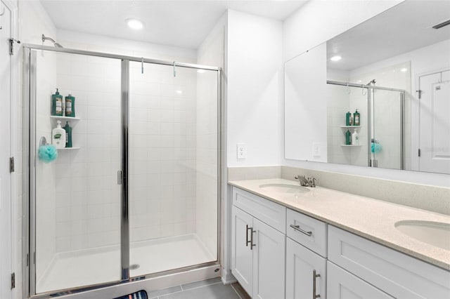 bathroom with vanity, tile patterned floors, and an enclosed shower