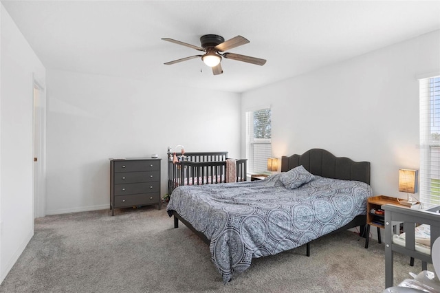 bedroom with multiple windows, carpet floors, and ceiling fan