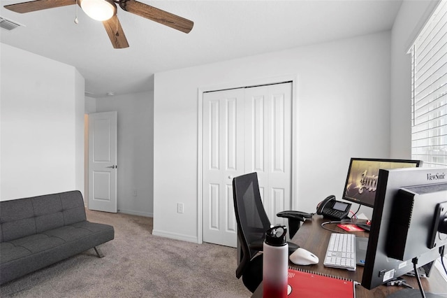 carpeted office space with ceiling fan