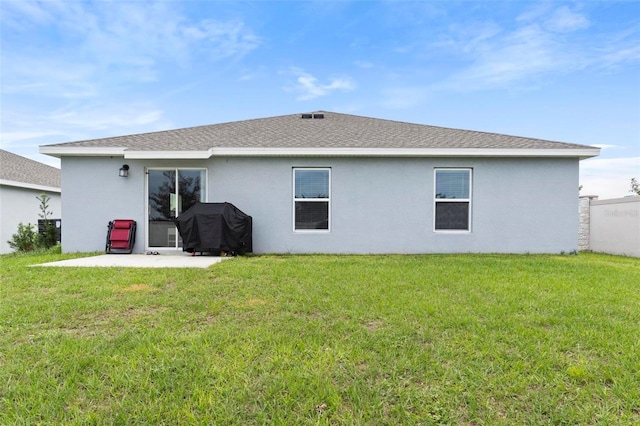 back of house featuring a patio and a lawn