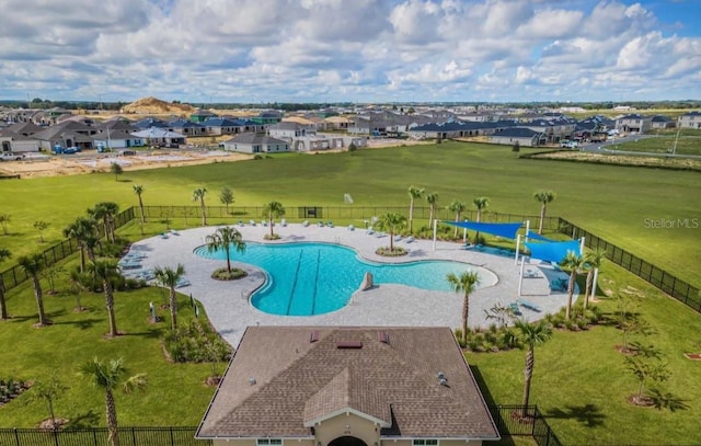 view of pool featuring a patio area and a yard