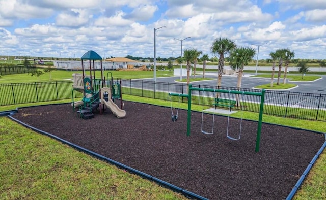 view of playground with a lawn