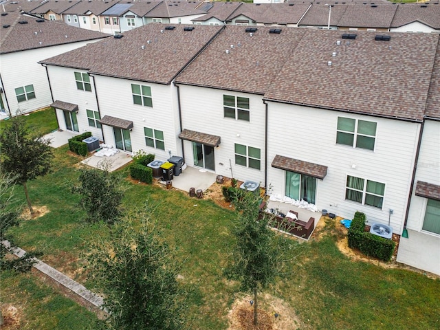 rear view of property featuring a patio area and a lawn