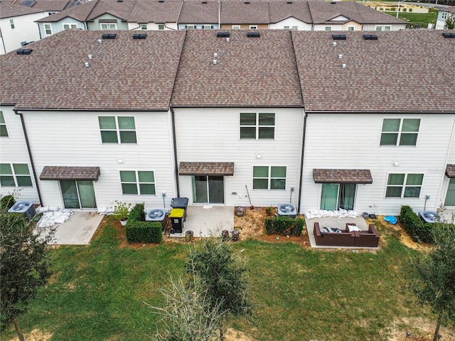 rear view of house with a patio, outdoor lounge area, and a lawn