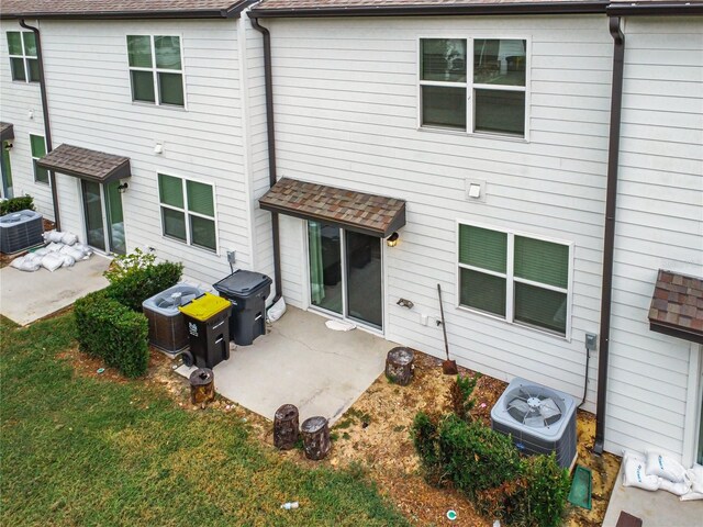 rear view of house with central air condition unit and a patio area