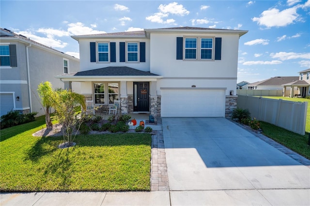 view of front of property with fence, driveway, covered porch, stucco siding, and a front lawn