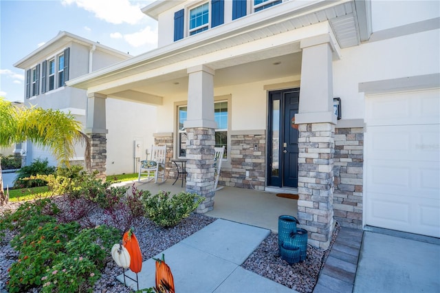 doorway to property featuring stone siding, a porch, and stucco siding