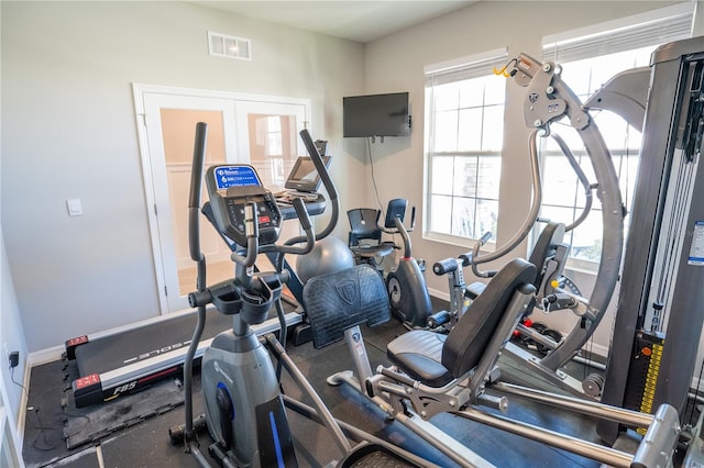 gym featuring french doors, visible vents, and baseboards