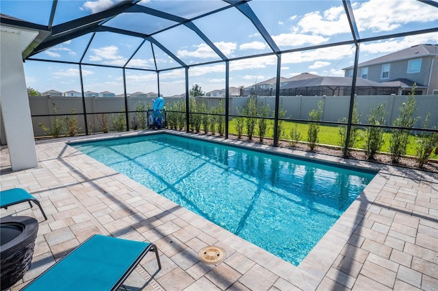 view of pool with a lanai, a patio area, a residential view, and a fenced in pool