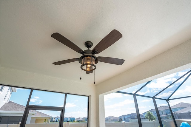 room details featuring a residential view, a sunroom, and ceiling fan