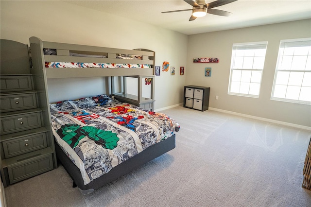 bedroom featuring baseboards, light carpet, and a ceiling fan