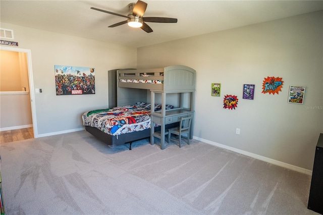 bedroom featuring visible vents, baseboards, ceiling fan, and light colored carpet