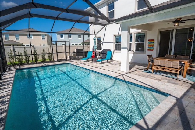 view of pool featuring a fenced in pool, ceiling fan, fence, a lanai, and a patio area