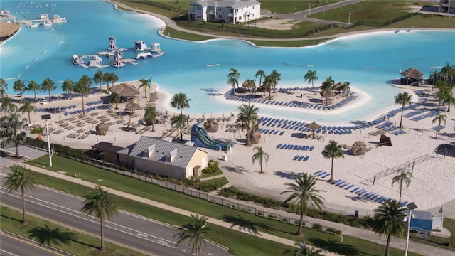 birds eye view of property featuring a water view and a view of the beach