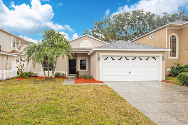 view of front of house with a garage and a front yard