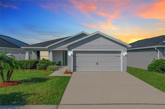 view of front facade featuring a yard and a garage