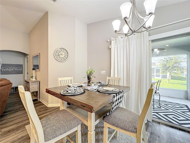 dining room featuring wood-type flooring and a chandelier