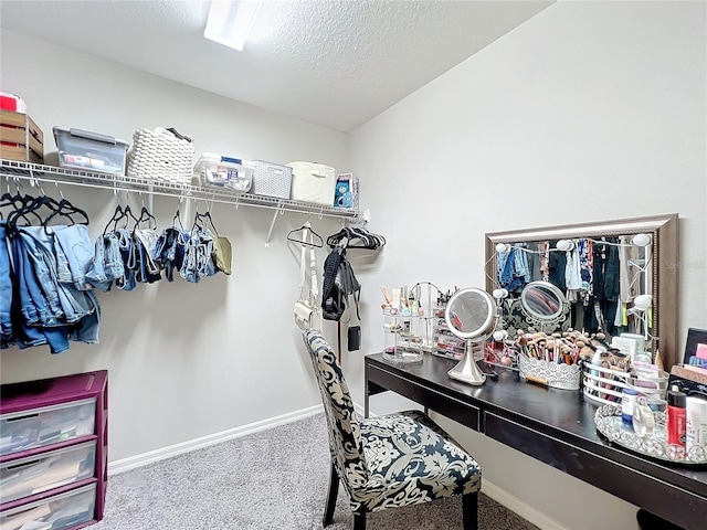 walk in closet featuring carpet flooring