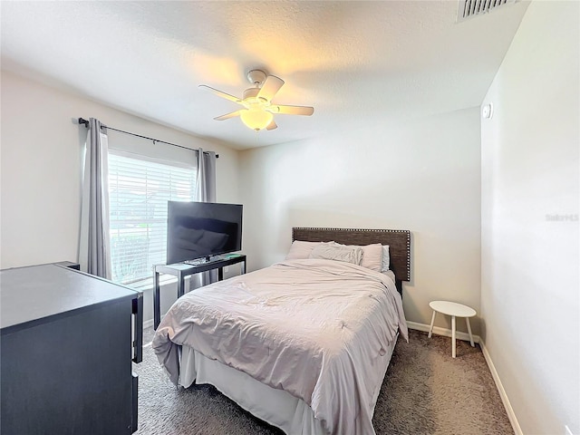 carpeted bedroom featuring a textured ceiling and ceiling fan