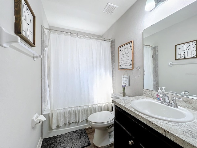 full bathroom featuring vanity, shower / tub combo with curtain, toilet, and hardwood / wood-style flooring