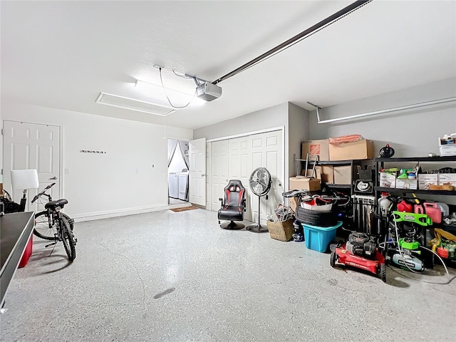 garage with a garage door opener and washer and dryer