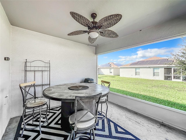 sunroom / solarium featuring plenty of natural light and ceiling fan