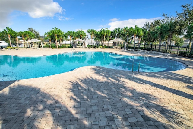 view of swimming pool featuring a gazebo and a patio area