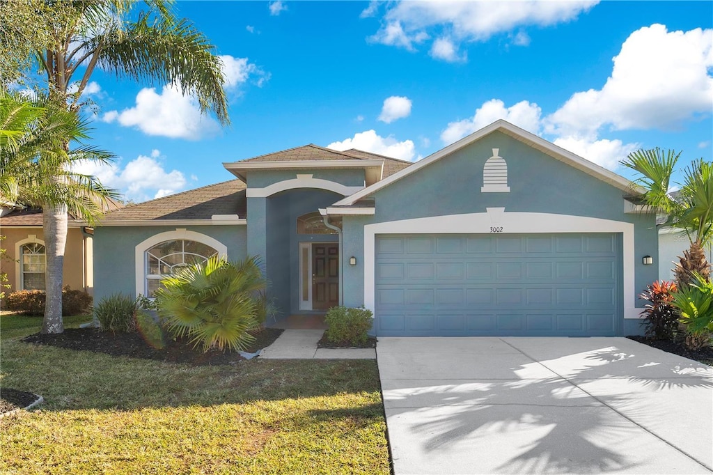 view of front facade with a garage and a front yard