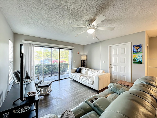 living room featuring a textured ceiling, hardwood / wood-style flooring, and ceiling fan