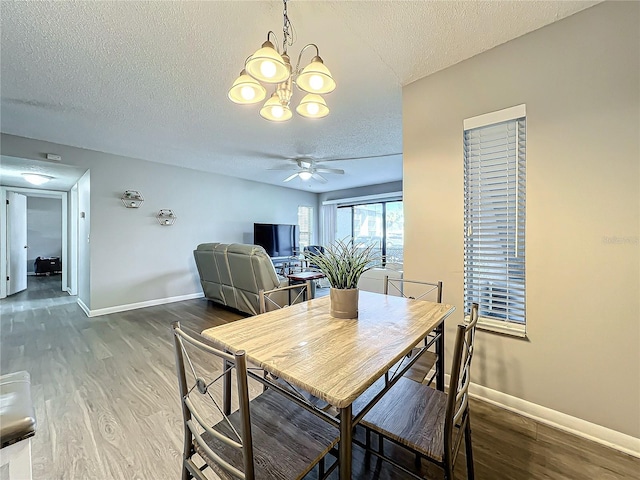 dining room featuring hardwood / wood-style floors, a textured ceiling, and ceiling fan with notable chandelier