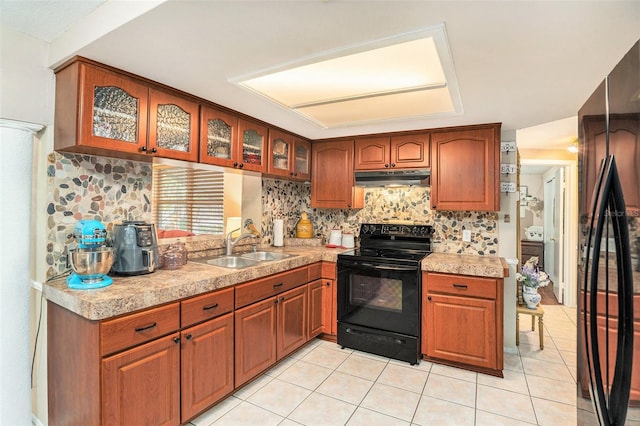 kitchen with black appliances, tasteful backsplash, sink, and light tile patterned flooring