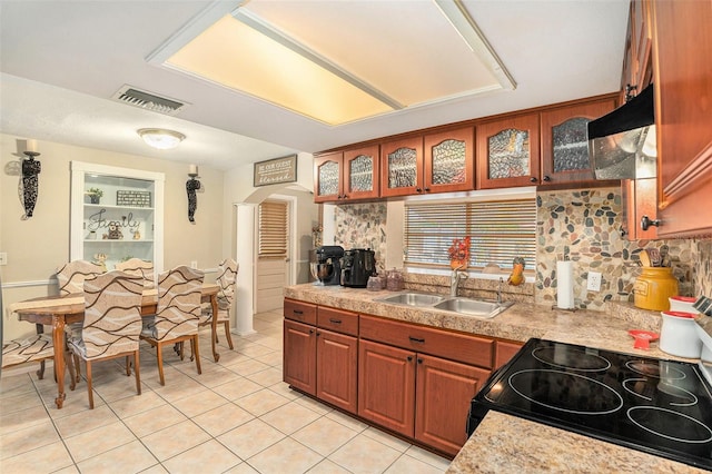 kitchen featuring sink, electric range, and light tile patterned floors