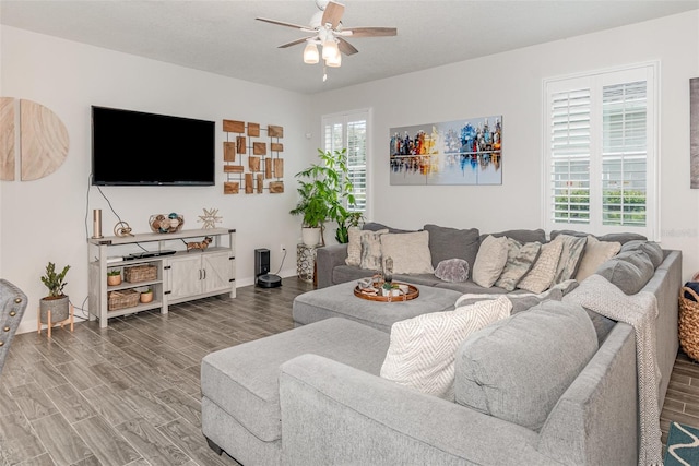 living room with ceiling fan, wood-type flooring, and a textured ceiling